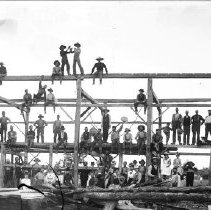 Glass plate negative image, barn raising